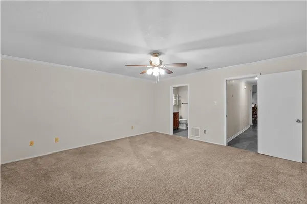 a view of a livingroom with a ceiling fan and window