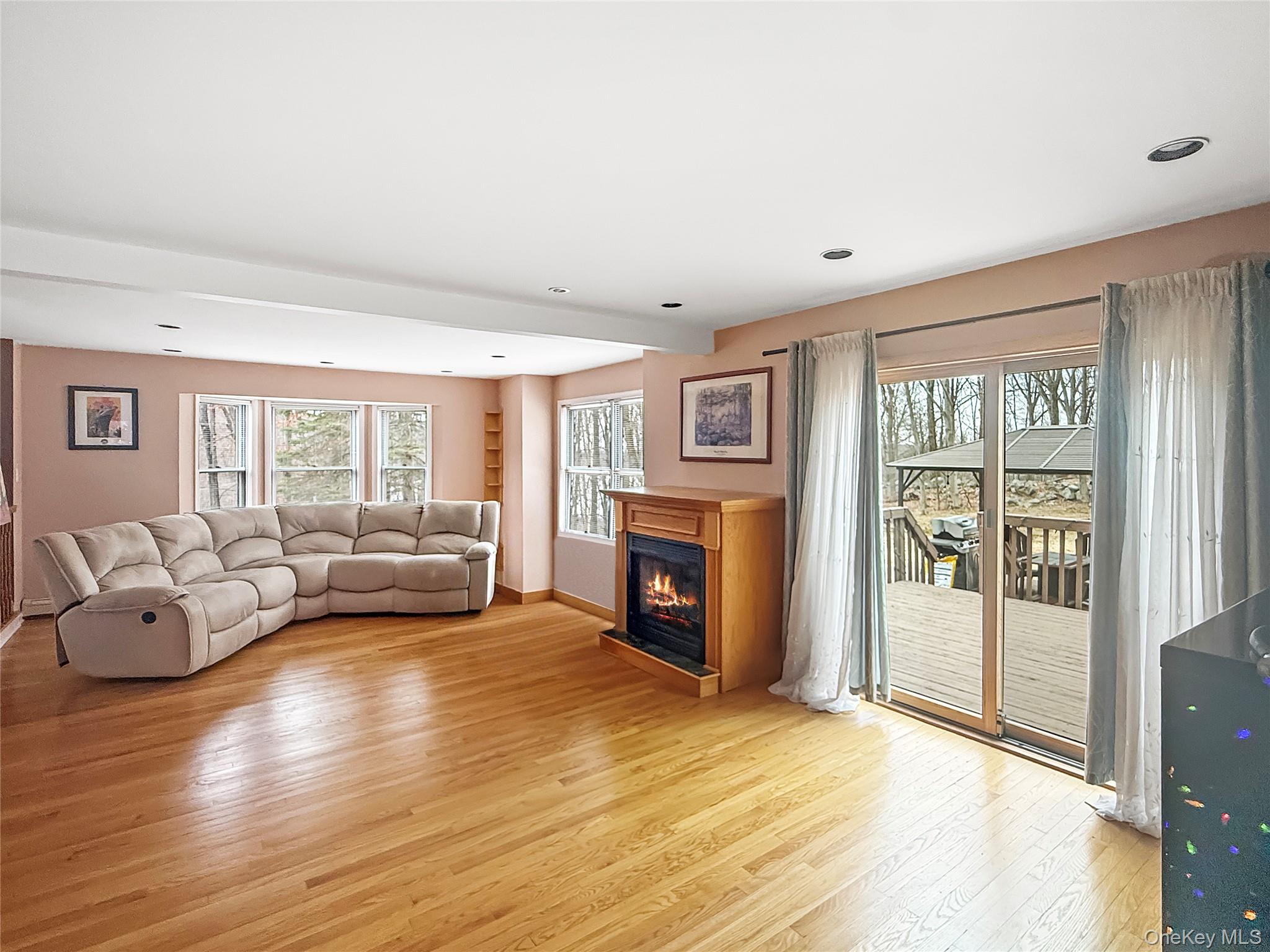 101 Travis Corners Road Garrison, NY 10524 - Photo 3 of 13 Gas fireplace with access to deck and patio
