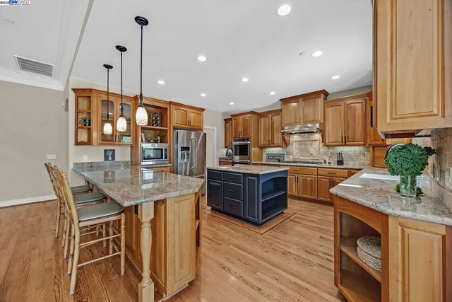 a dining room with wooden floor glass table and chairs