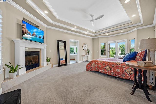 a bedroom with a large bed and a chandelier