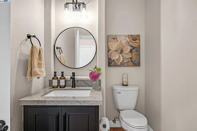 a view of a patio with couches and table and chairs with wooden floor and fence