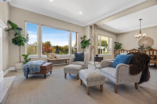 a dining room with furniture a chandelier and wooden floor