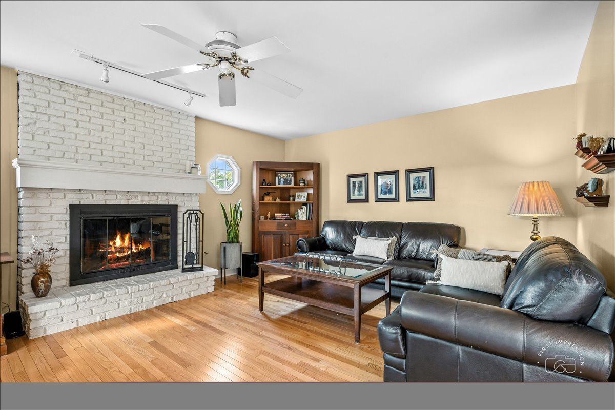 1432 Calcutta Lane Naperville, IL 60563 - Photo 16 of 43 a living room with furniture and a fireplace