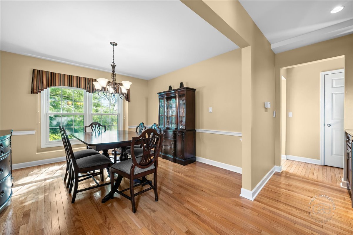 1432 Calcutta Lane Naperville, IL 60563 - Photo 23 of 43 a view of a dining room with furniture window and wooden floor