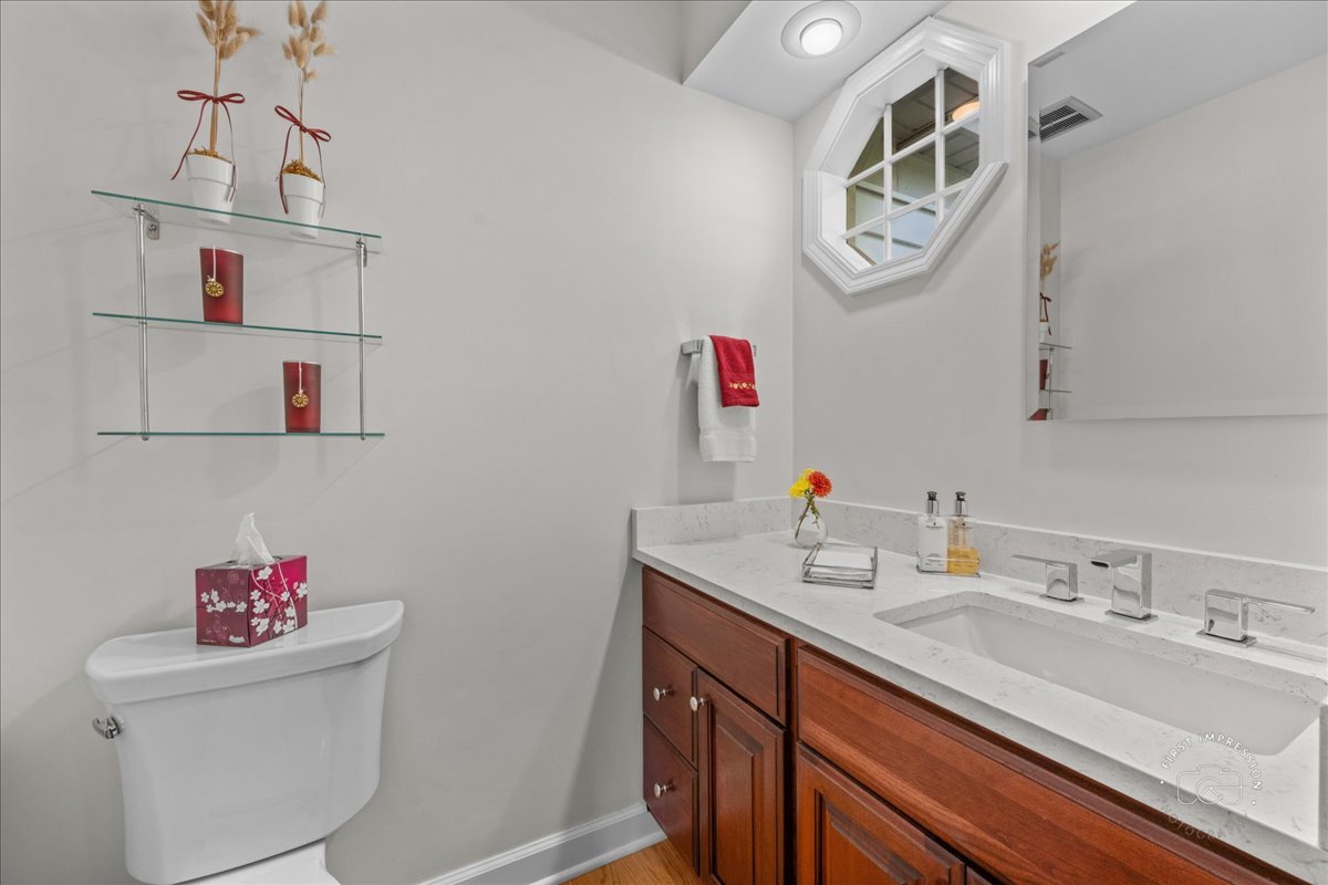 1432 Calcutta Lane Naperville, IL 60563 - Photo 25 of 43 a bathroom with a sink vanity and toilet