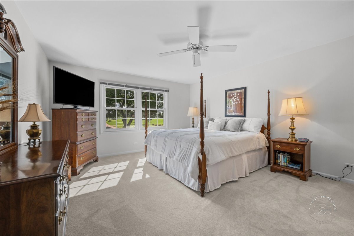 1432 Calcutta Lane Naperville, IL 60563 - Photo 27 of 43 a spacious bedroom with a bed and a flat screen tv