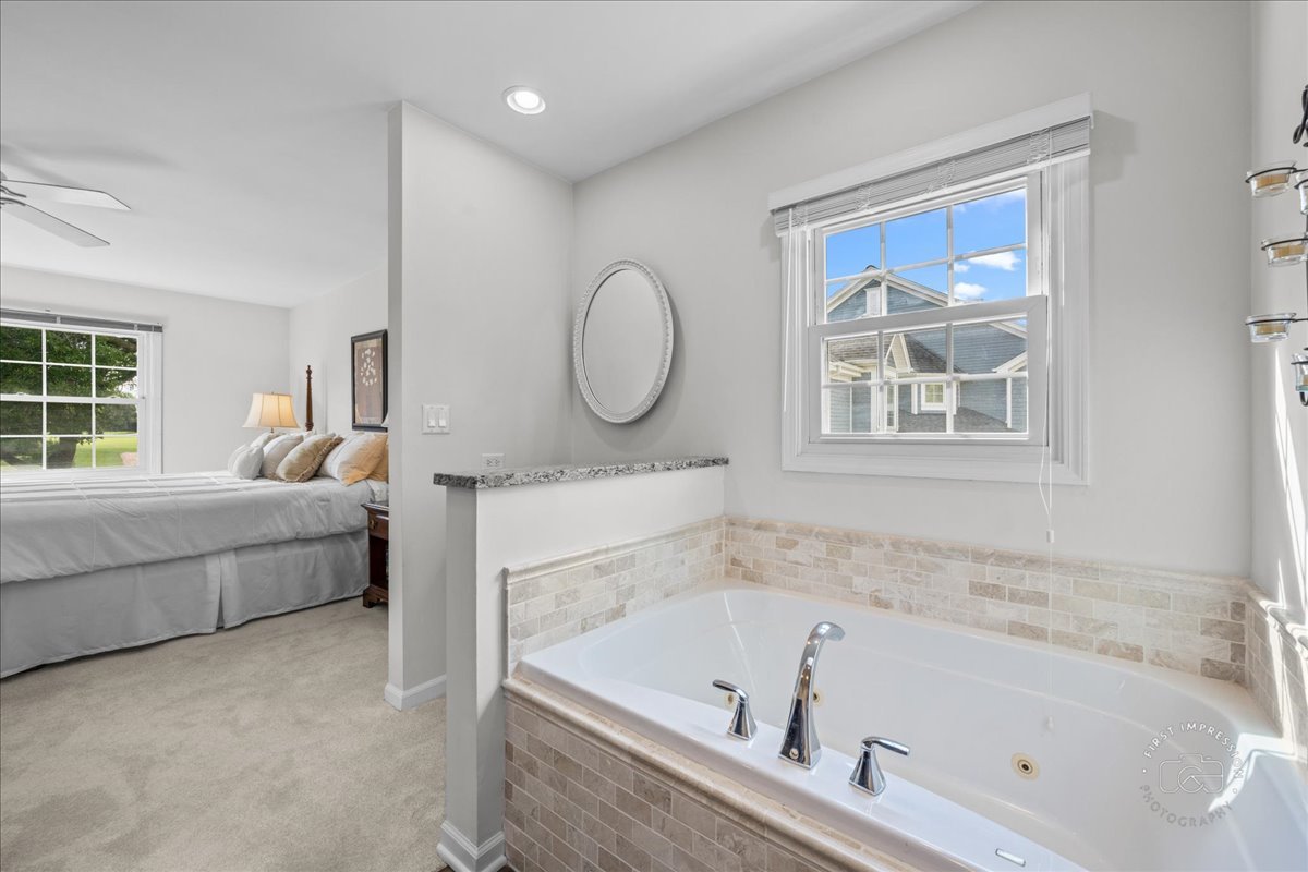 1432 Calcutta Lane Naperville, IL 60563 - Photo 30 of 43 a bathroom with a tub sink and mirror