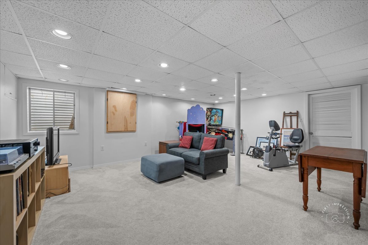 1432 Calcutta Lane Naperville, IL 60563 - Photo 37 of 43 a living room with furniture and a flat screen tv