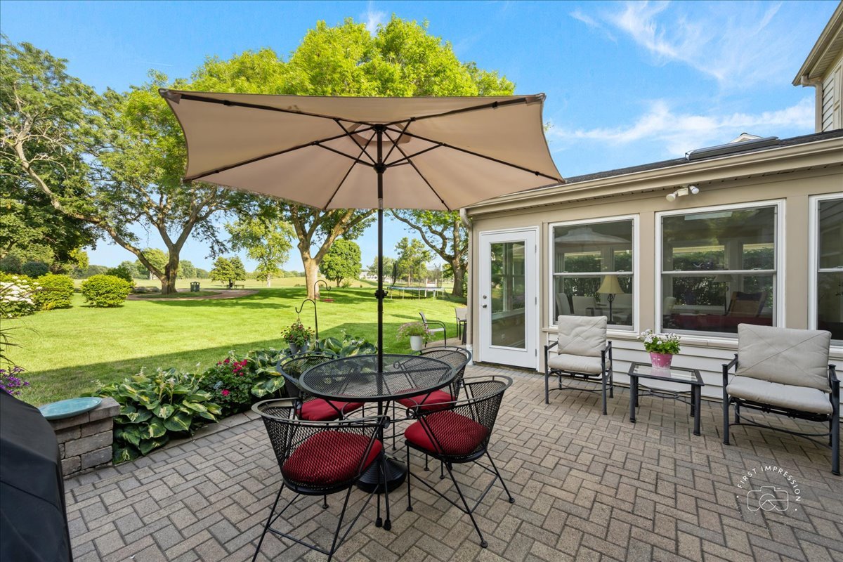 1432 Calcutta Lane Naperville, IL 60563 - Photo 38 of 43 a chairs and table in patio with a umbrella