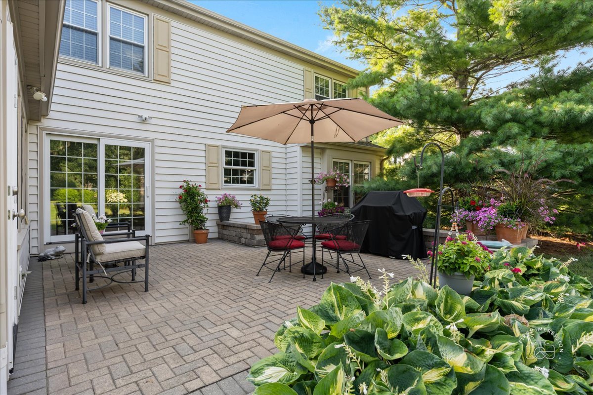1432 Calcutta Lane Naperville, IL 60563 - Photo 39 of 43 a view of a patio with a table and chairs under an umbrella