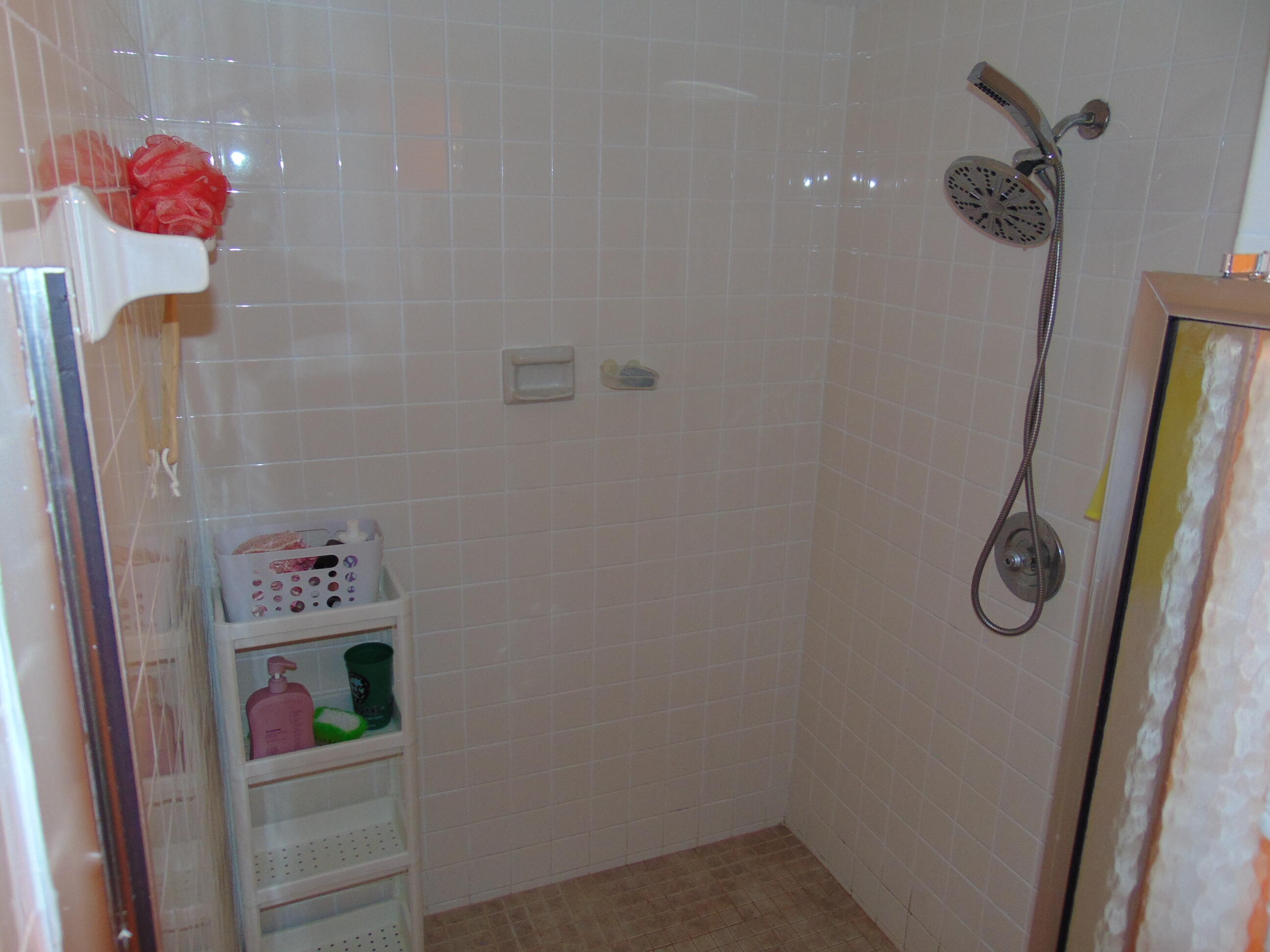9220 Southwest 14th Street, Unit 3103 Boca Raton, FL 33428 - Photo 22 of 58 a bathroom with a refrigerator and a shower