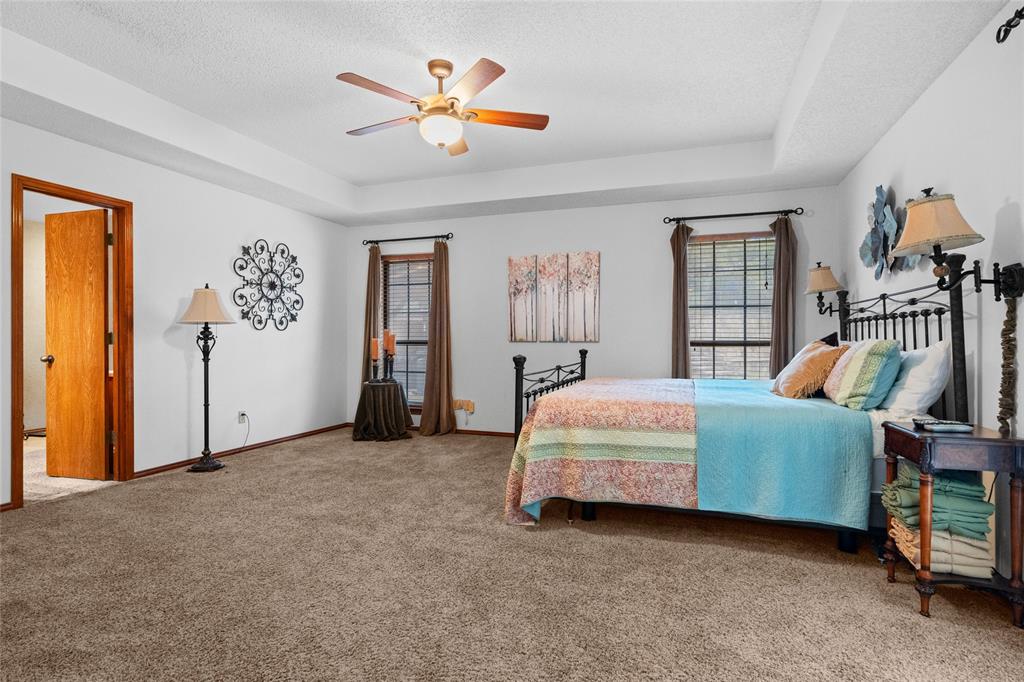 5840 Crystal Drive Midlothian, TX 76065 - Photo 20 of 36 a bedroom with a bed and a chandelier