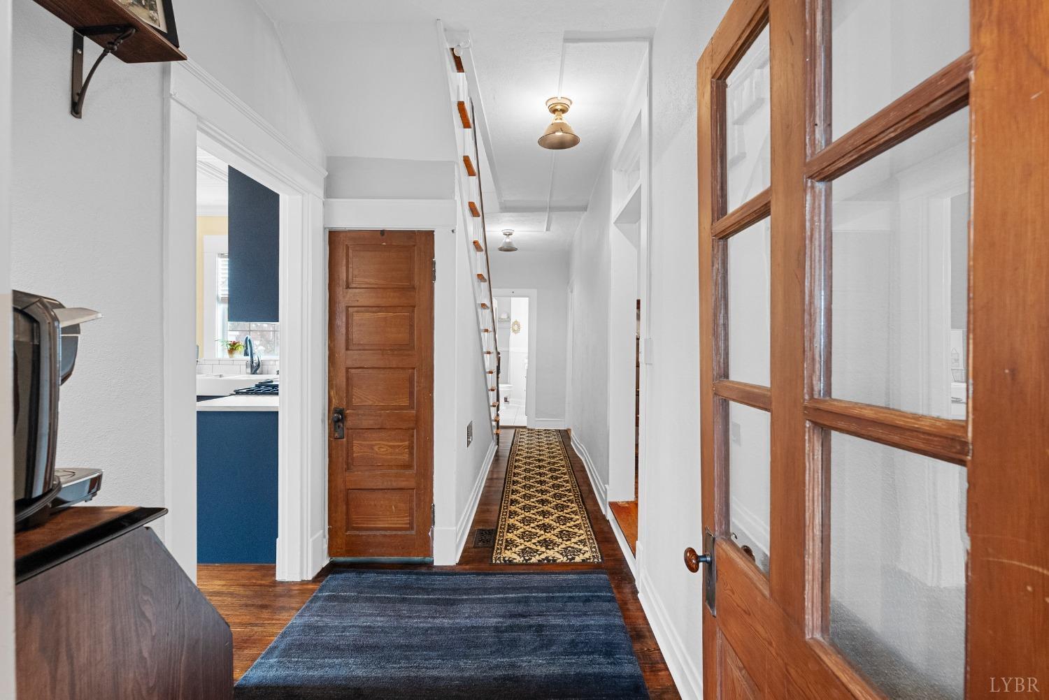 243 South Main Street Amherst, VA 24521 - Photo 14 of 57 a view of a hallway with wooden floor and staircase