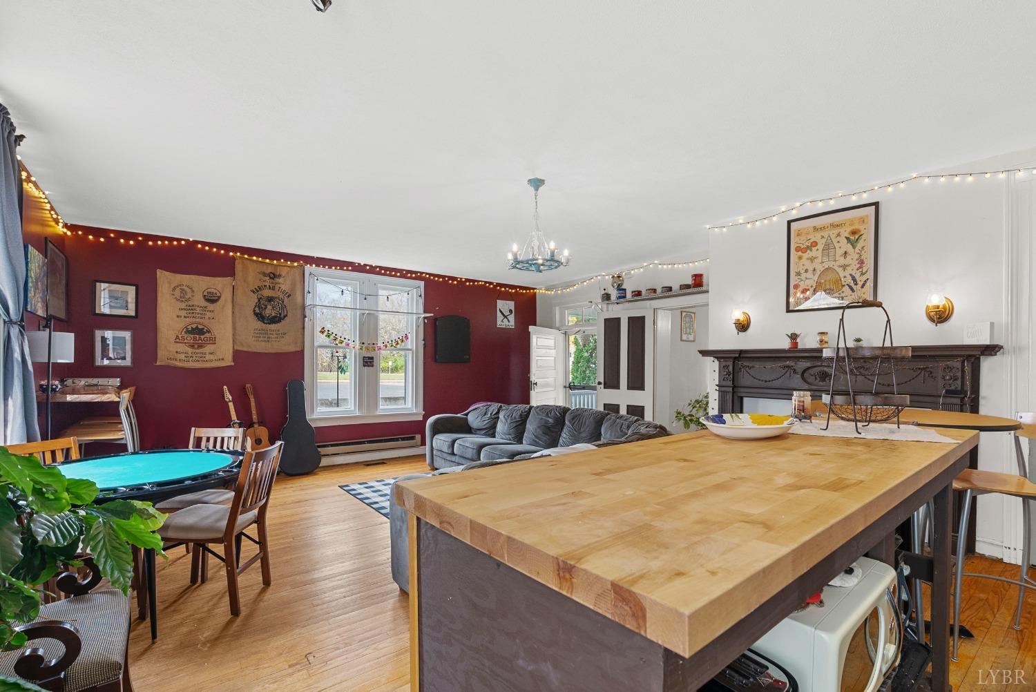 243 South Main Street Amherst, VA 24521 - Photo 25 of 57 a living room with dining table and chairs with wooden floor