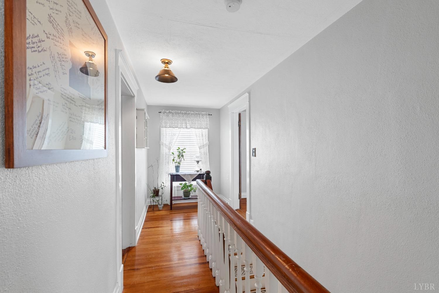 243 South Main Street Amherst, VA 24521 - Photo 29 of 57 a view of a hallway with wooden floor and staircase