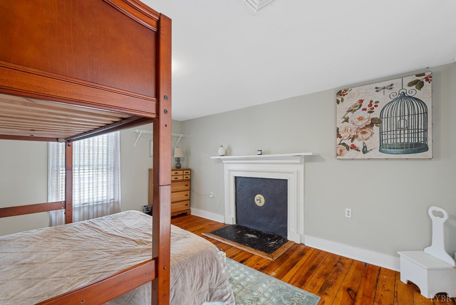 243 South Main Street Amherst, VA 24521 - Photo 43 of 57 a bedroom with a bed and a fireplace