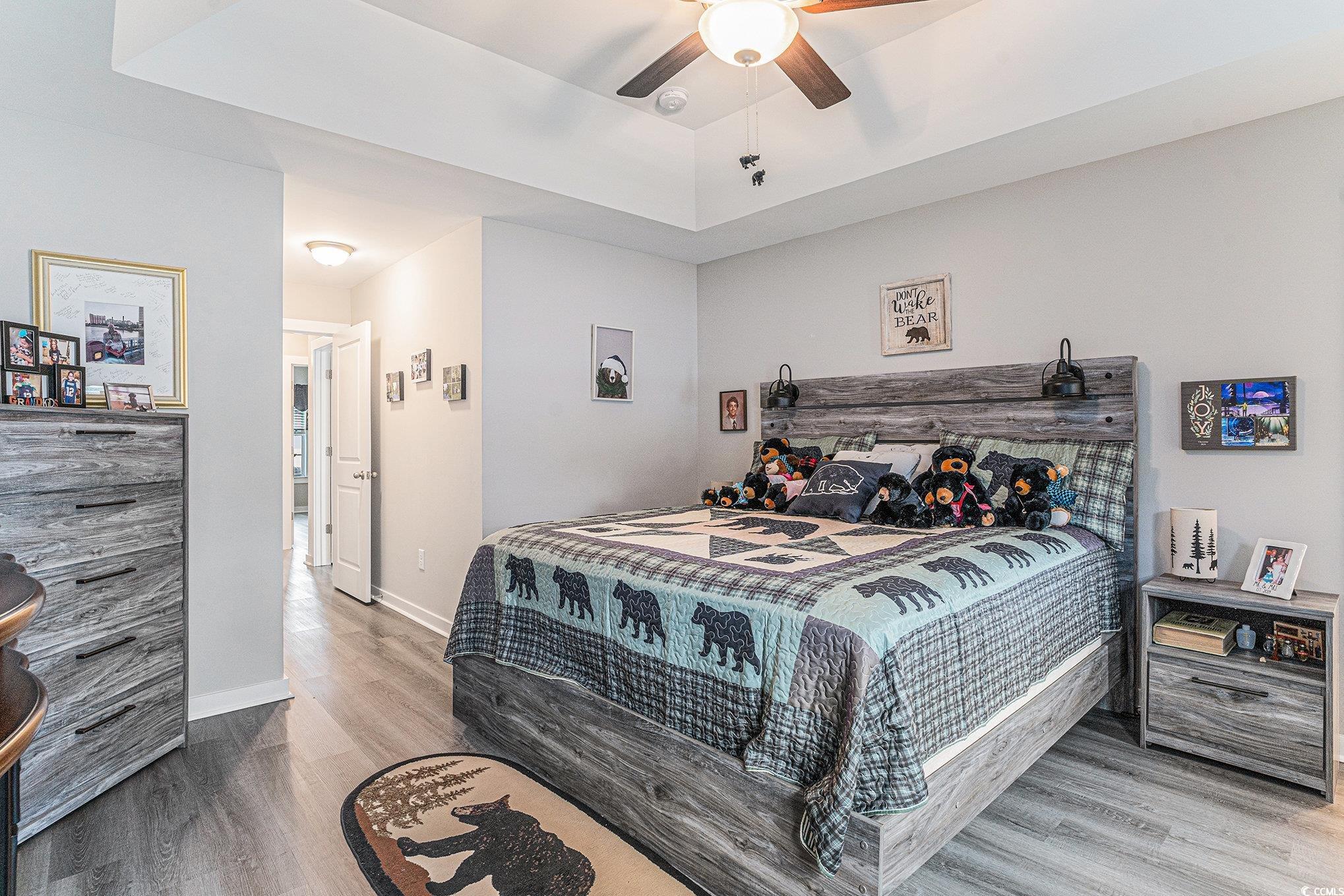 2602 Floribunda Lane Conway, SC 29527 - Photo 11 of 28 Bedroom featuring light wood finished floors, ceiling fan, and a tray ceiling