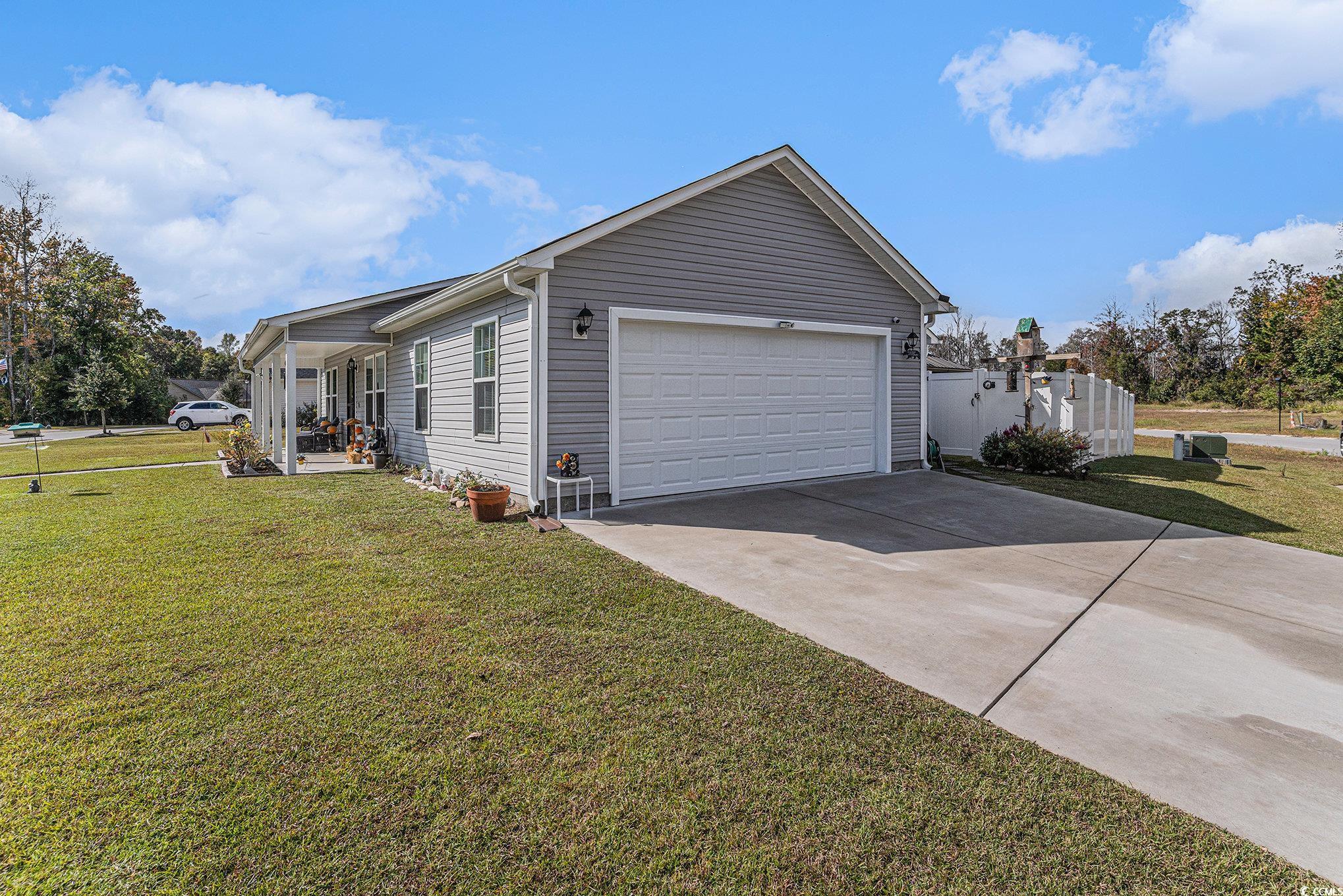 2602 Floribunda Lane Conway, SC 29527 - Photo 2 of 28 View of property exterior featuring a lawn, concrete driveway, and an attached garage