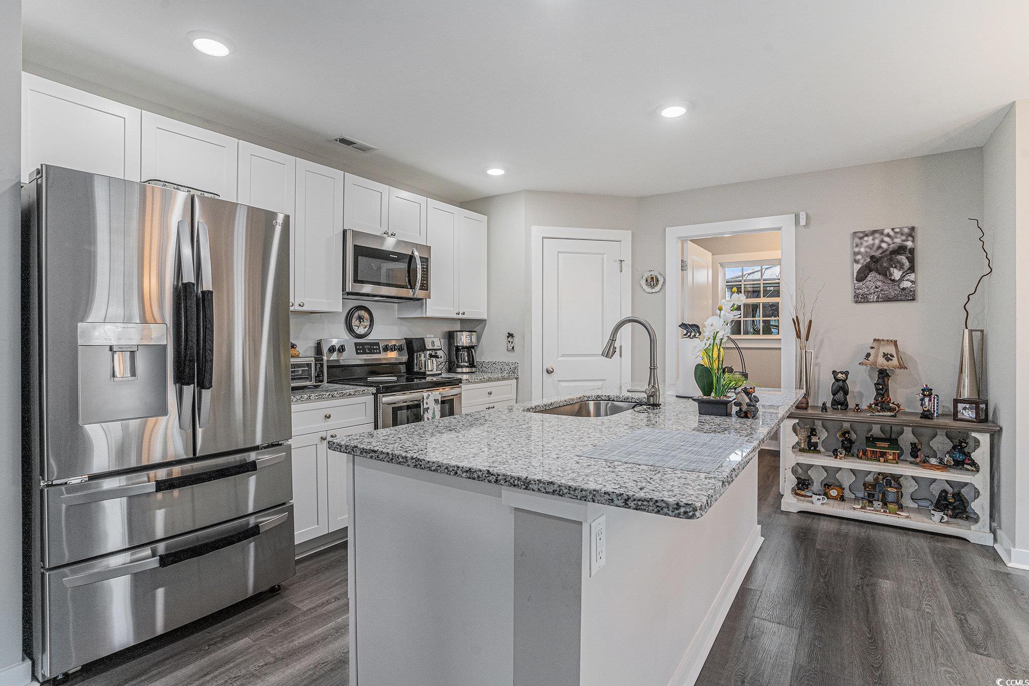 2602 Floribunda Lane Conway, SC 29527 - Photo 7 of 28 Kitchen featuring stainless steel appliances, light stone counters, dark wood-type flooring, white cabinets, and recessed lighting