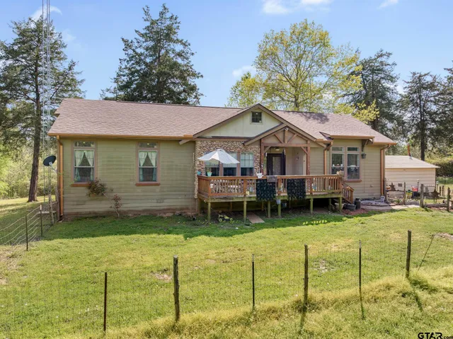 a backyard of a house with yard fire pit and outdoor seating