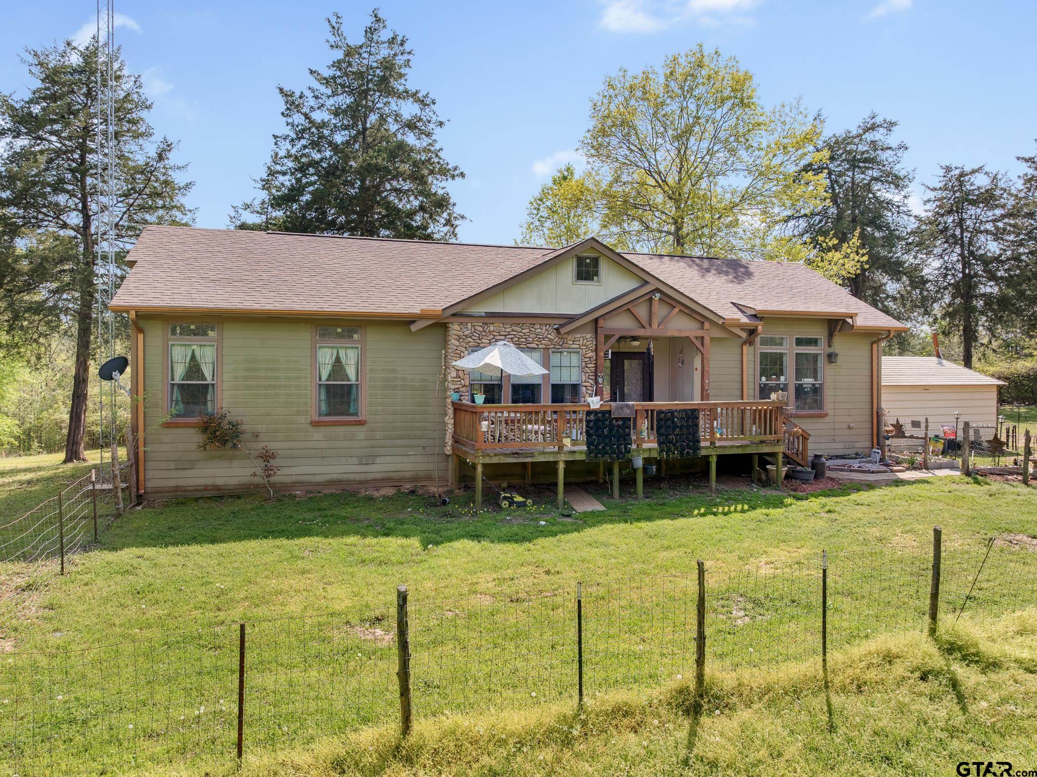 a backyard of a house with yard fire pit and outdoor seating