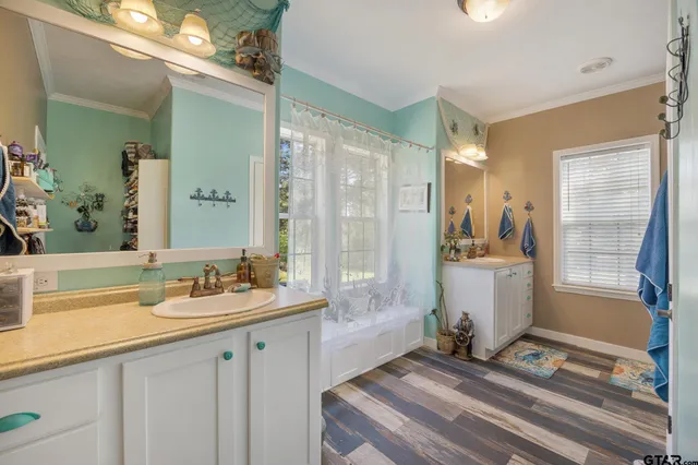 a spacious bathroom with a sink double vanity and a mirror