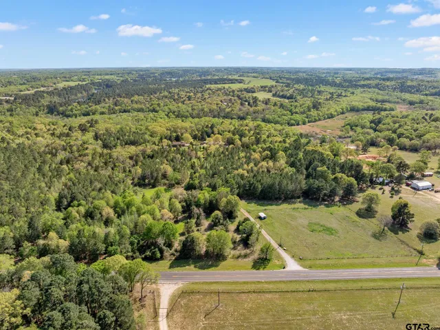 a view of a field with an ocean view