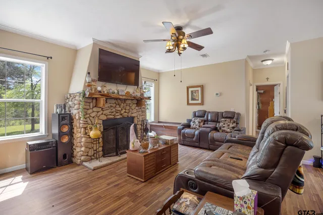 a living room with furniture fireplace and flat screen tv