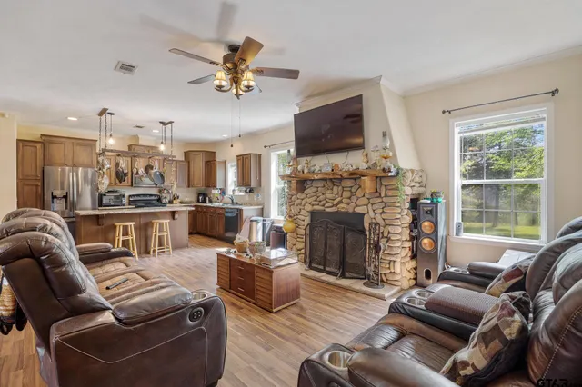 a living room with furniture fireplace and a flat screen tv