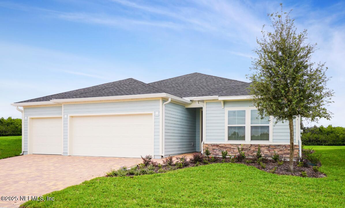76104 Estuary Way Yulee, FL 32097 - Photo 40 of 41 a front view of a house with a garden