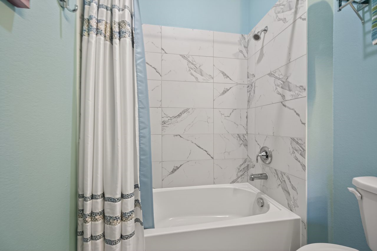 16707 Seminole Ridge Drive Cypress, TX 77433 - Photo 18 of 26 a bathroom with bathtub and shower