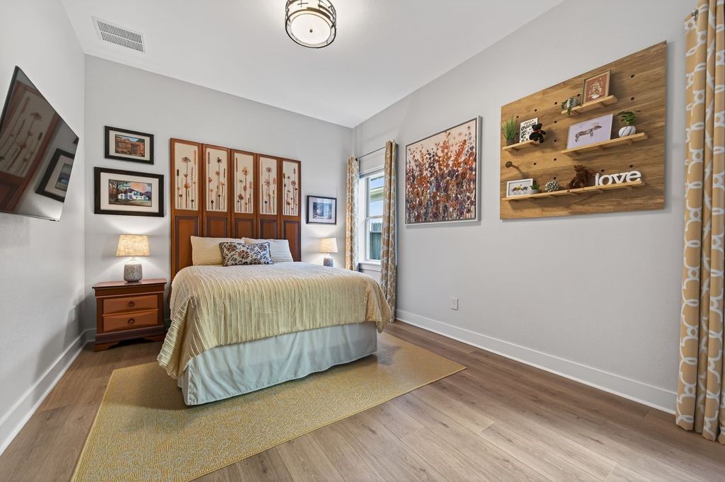 16707 Seminole Ridge Drive Cypress, TX 77433 - Photo 19 of 26 a bedroom with a bed and painting on the wall