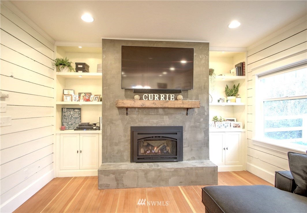 12814 Farm To Market Road Mount Vernon, WA 98273 - Photo 4 of 32 a living room with a fireplace and a wooden floor