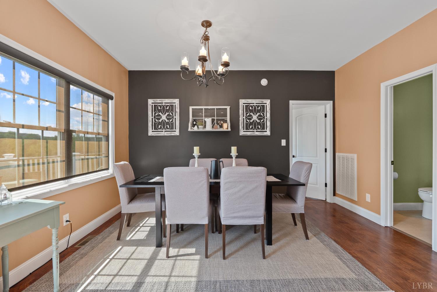 106 Nettie Court Lynchburg, VA 24502 - Photo 13 of 55 a view of a dining room with furniture a chandelier and wooden floor