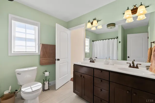 a bedroom with furniture and a large window