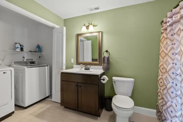 a front view of house with yard and trees in the background