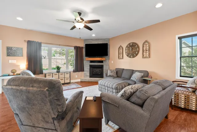 a living room with furniture fireplace and a large window