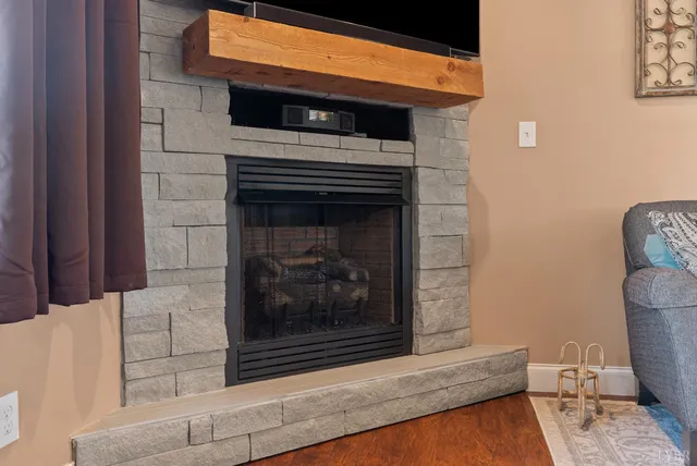 a kitchen with stainless steel appliances granite countertop a table chairs sink and cabinets