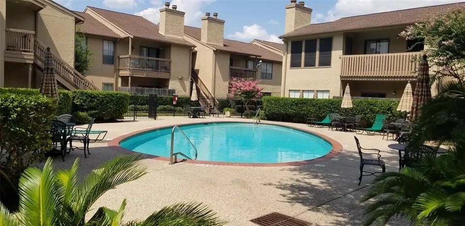 a swimming pool with outdoor seating and yard