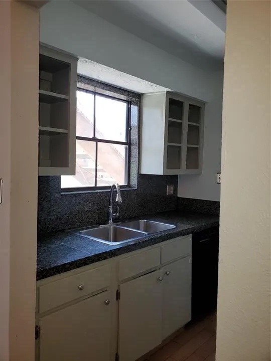 5000 Milwee Street, Unit 44 Houston, TX 77092 - Photo 12 of 16 a kitchen with a sink stove and cabinets