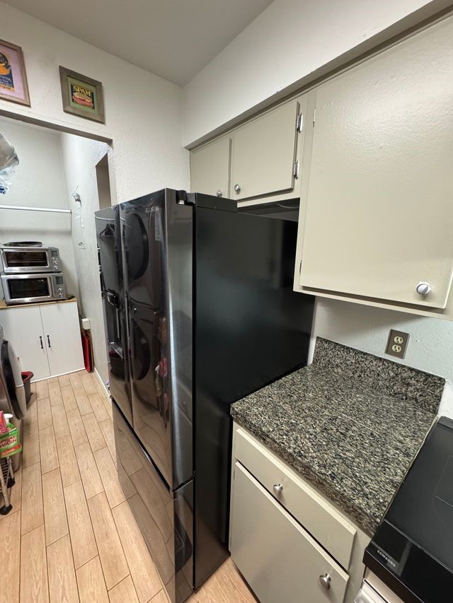 5000 Milwee Street, Unit 44 Houston, TX 77092 - Photo 8 of 16 a kitchen with a refrigerator and a stove top oven