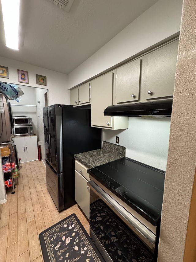 5000 Milwee Street, Unit 44 Houston, TX 77092 - Photo 10 of 16 a kitchen with stainless steel appliances granite countertop a refrigerator and a stove top oven