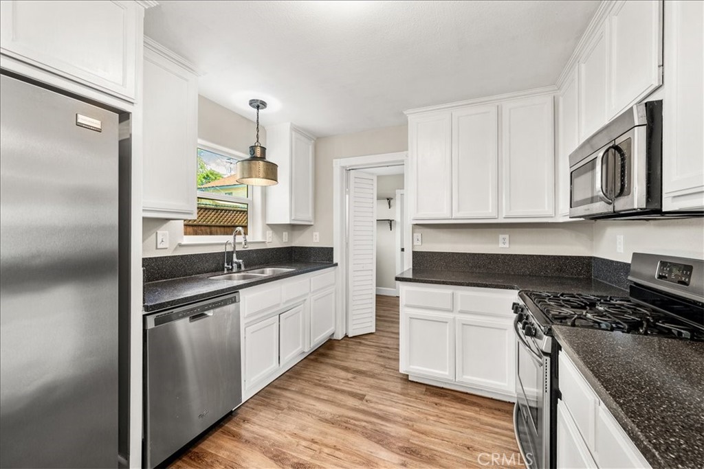 7687 Sinaloa Avenue Atascadero, CA 93422 - Photo 11 of 34 a kitchen with stainless steel appliances granite countertop a sink stove and refrigerator