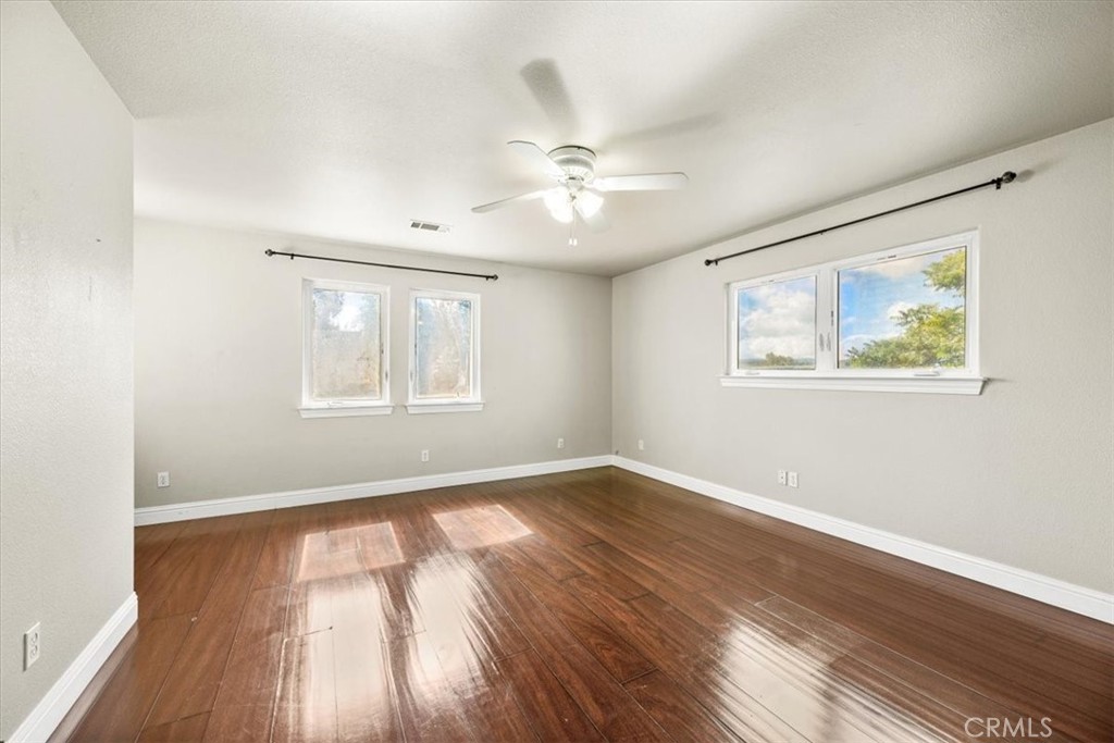 7687 Sinaloa Avenue Atascadero, CA 93422 - Photo 15 of 34 a view of an empty room with wooden floor and a window