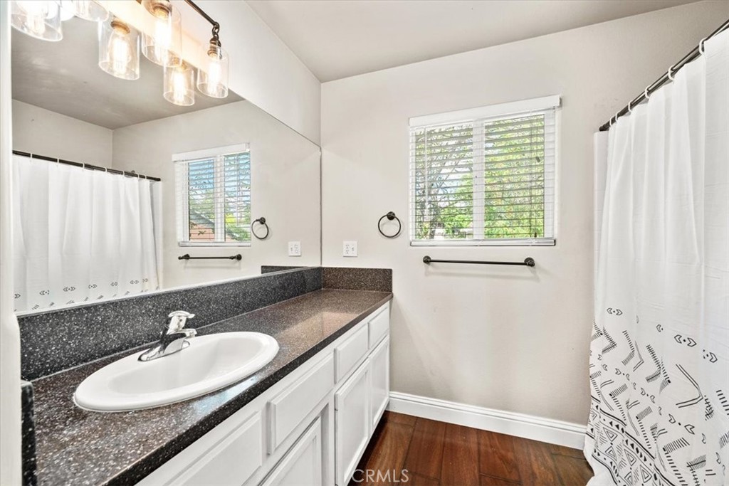 7687 Sinaloa Avenue Atascadero, CA 93422 - Photo 19 of 34 a bathroom with a granite countertop sink and a window