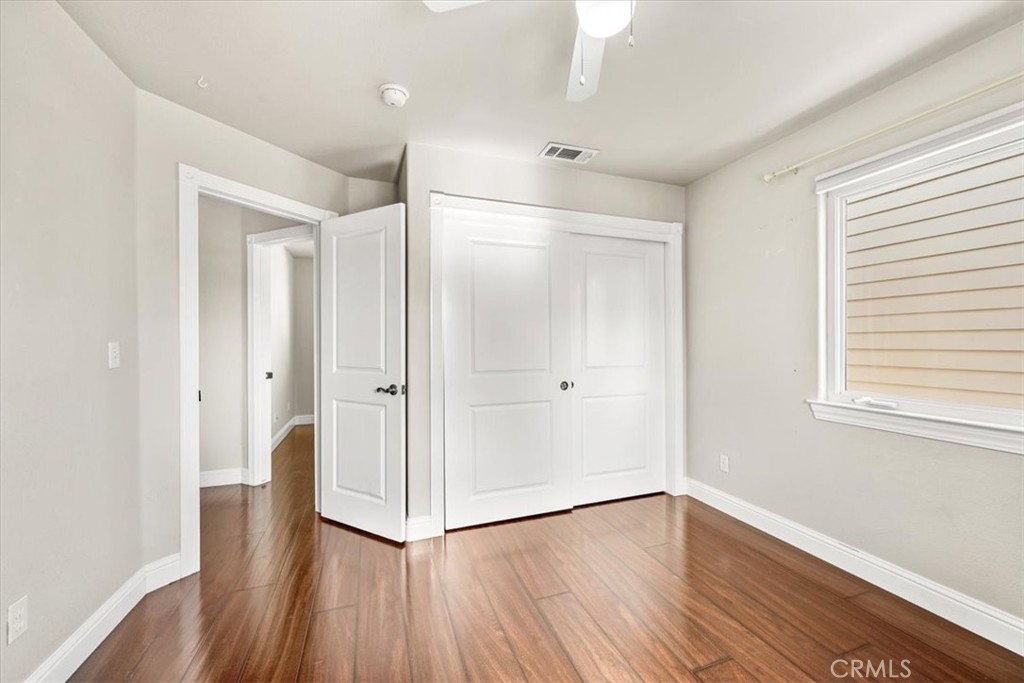 7687 Sinaloa Avenue Atascadero, CA 93422 - Photo 21 of 34 a view of empty room with wooden floor and window