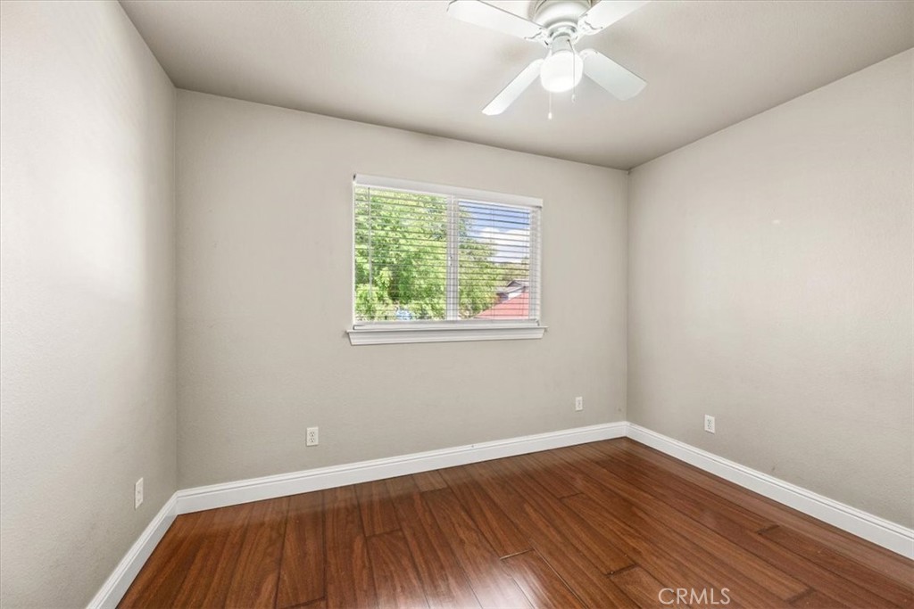 7687 Sinaloa Avenue Atascadero, CA 93422 - Photo 23 of 34 an empty room with wooden floor and windows