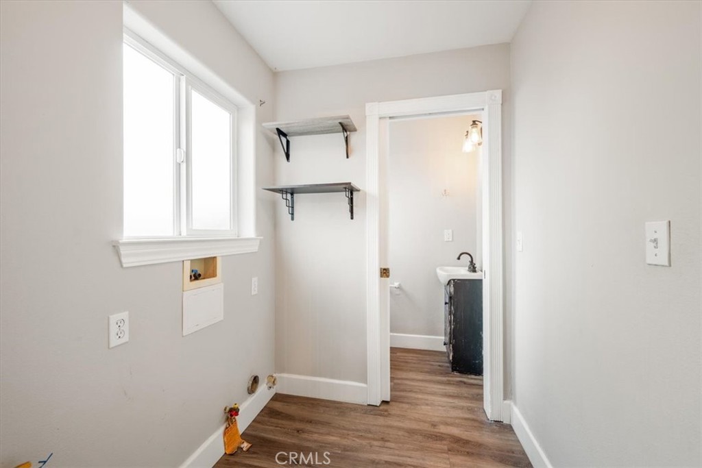 7687 Sinaloa Avenue Atascadero, CA 93422 - Photo 25 of 34 a view of hallway with window and wooden floor