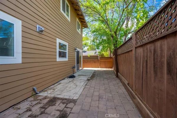 a view of balcony with wooden floor and fence and a pot