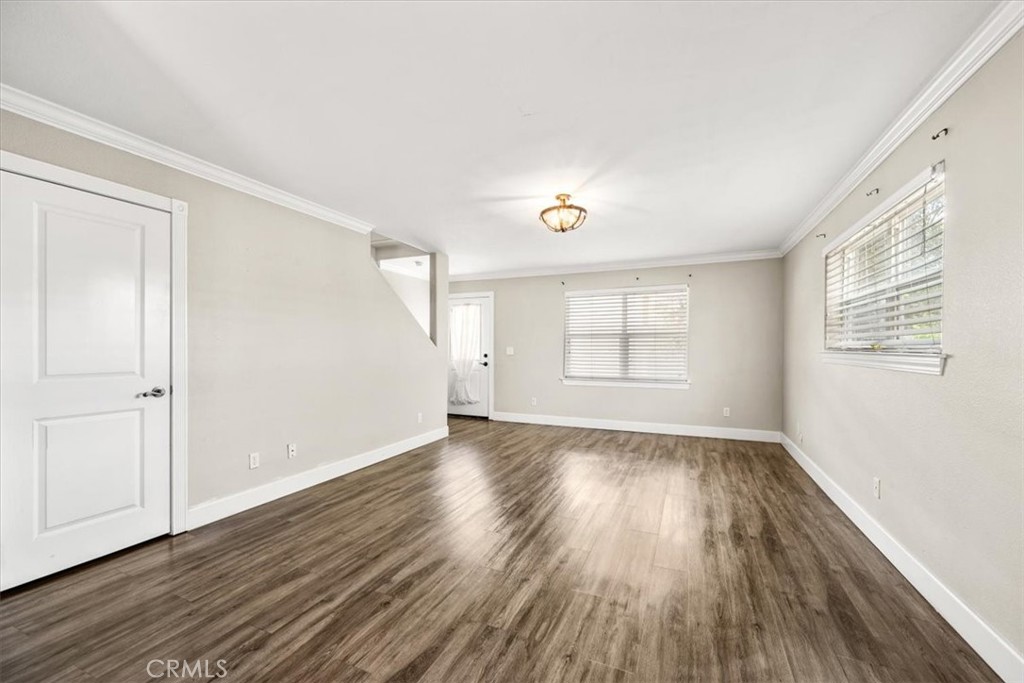 7687 Sinaloa Avenue Atascadero, CA 93422 - Photo 9 of 34 a view of an empty room with wooden floor and a window